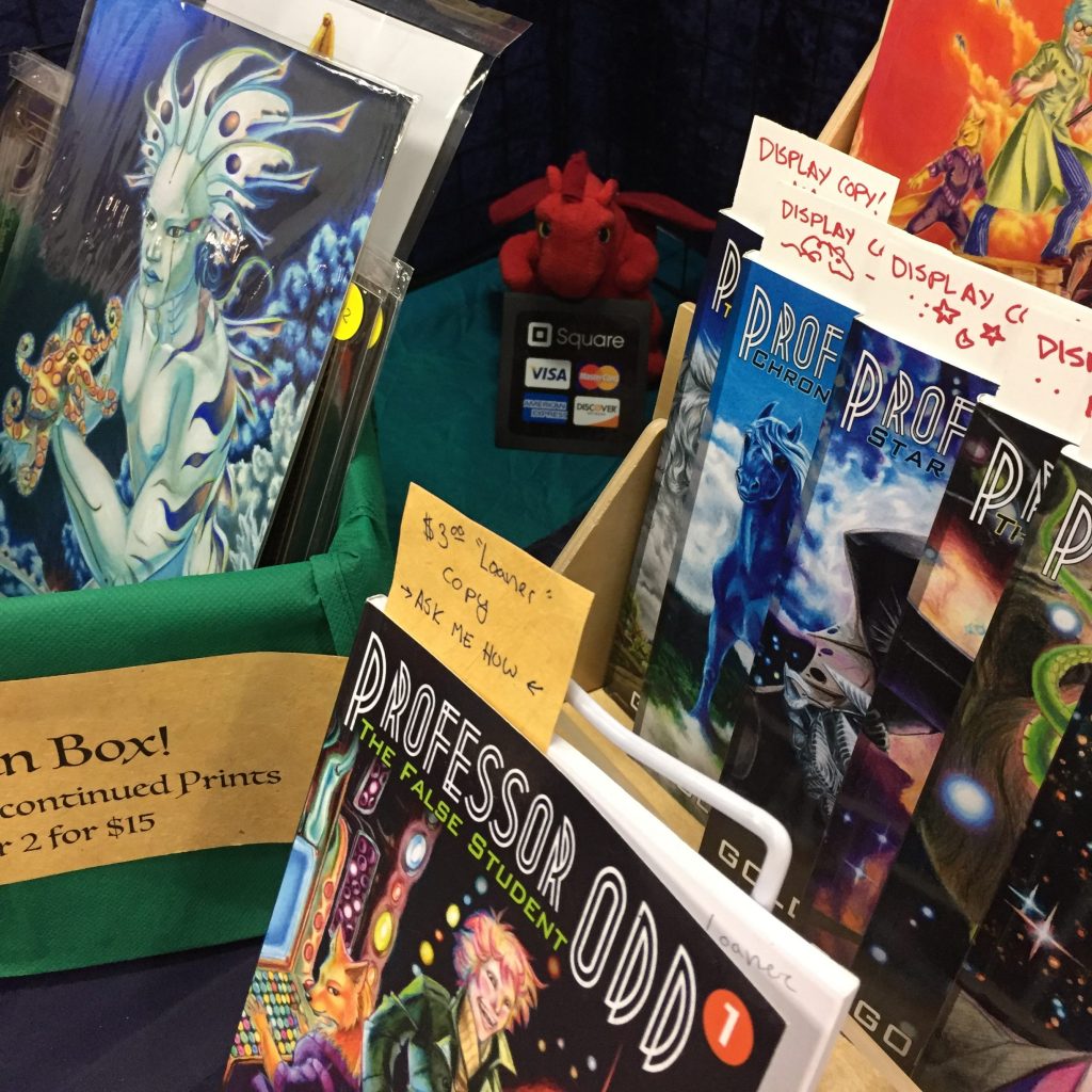 Photo of books and prints displayed on a table